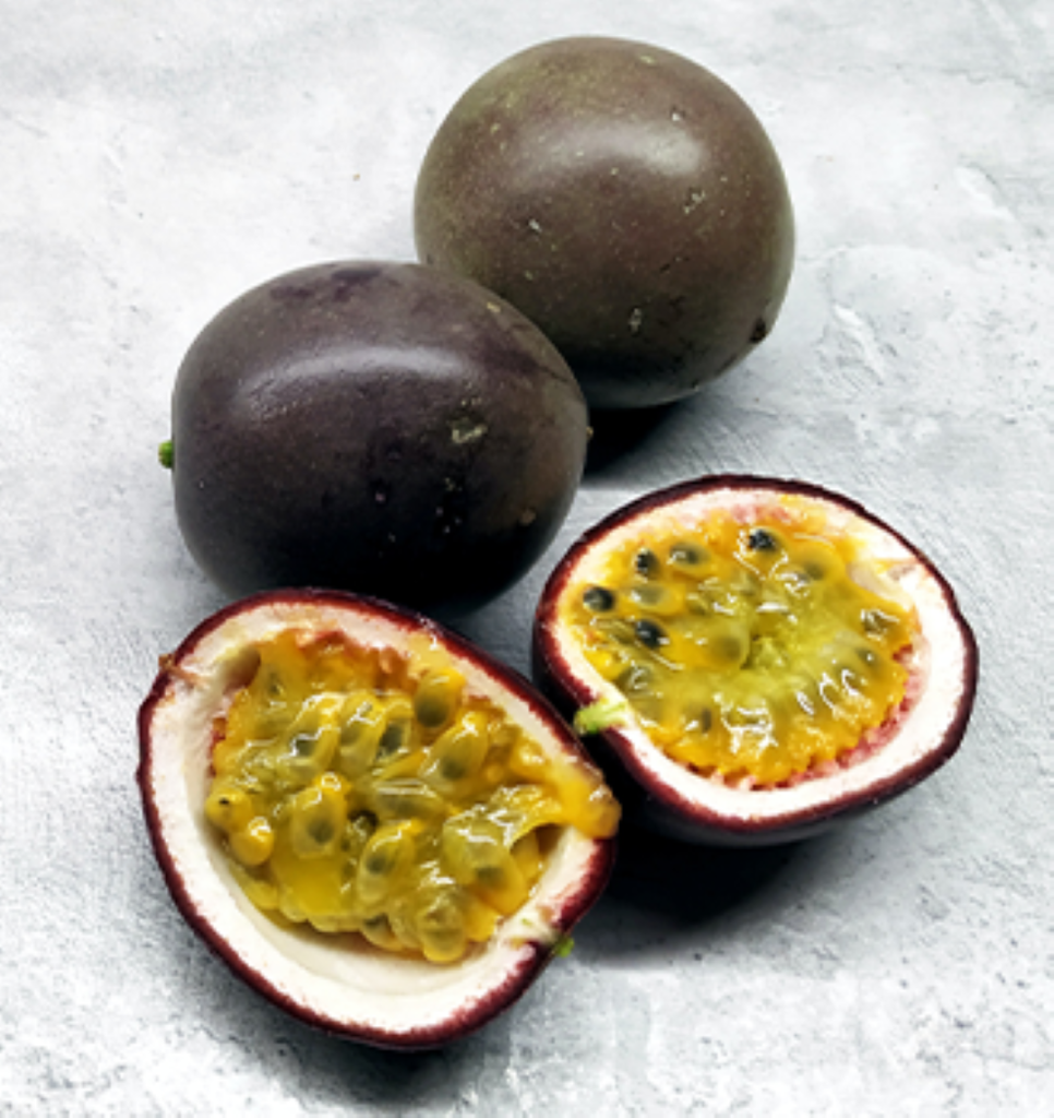 Three passionfruits, one cut in half